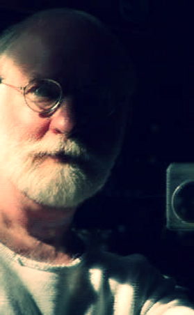 A man with glasses and white beard.