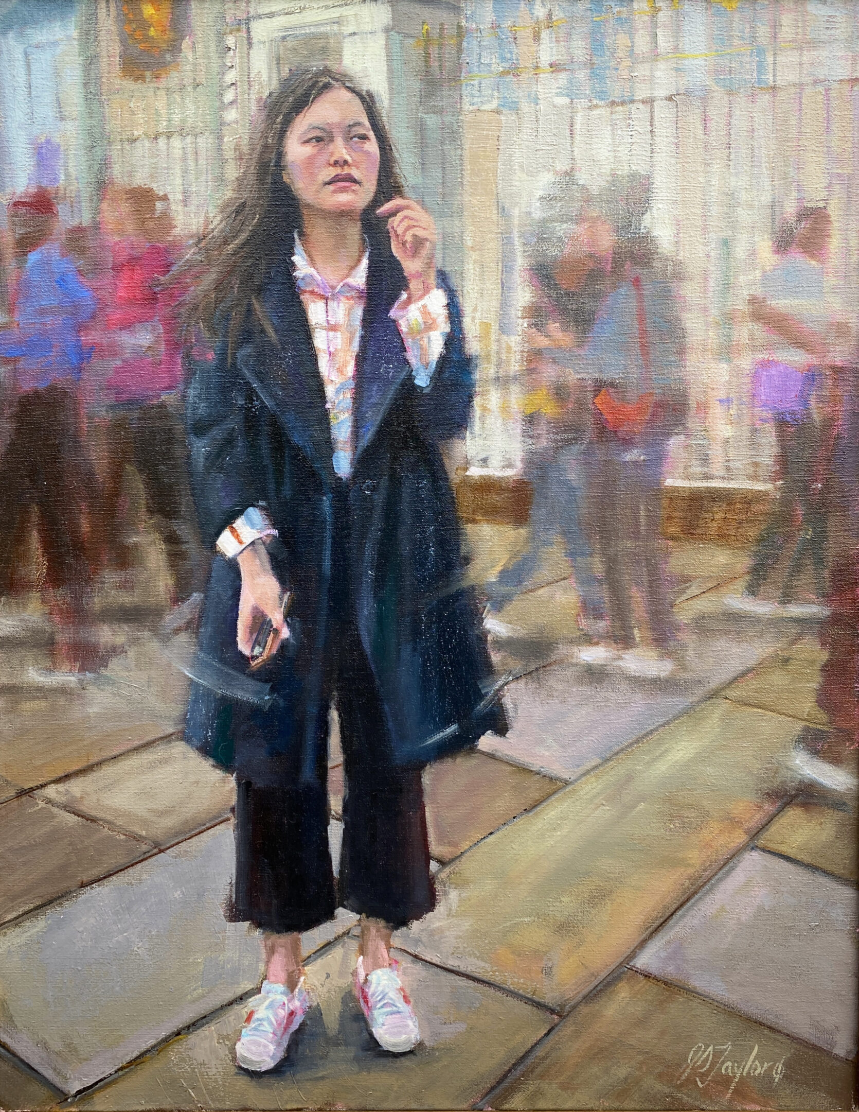 A woman standing on the sidewalk talking on her phone.