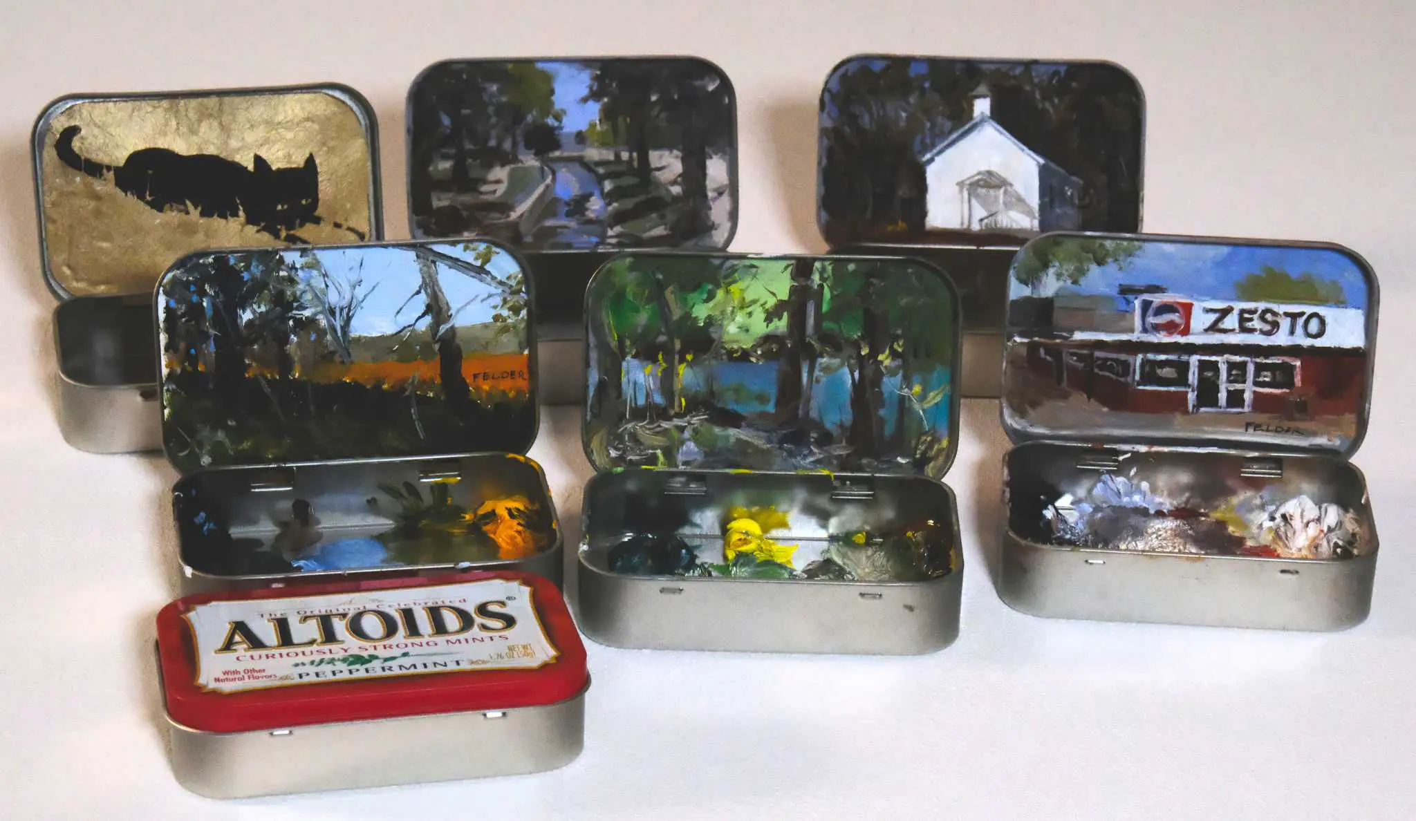 A bunch of tin boxes with pictures on them