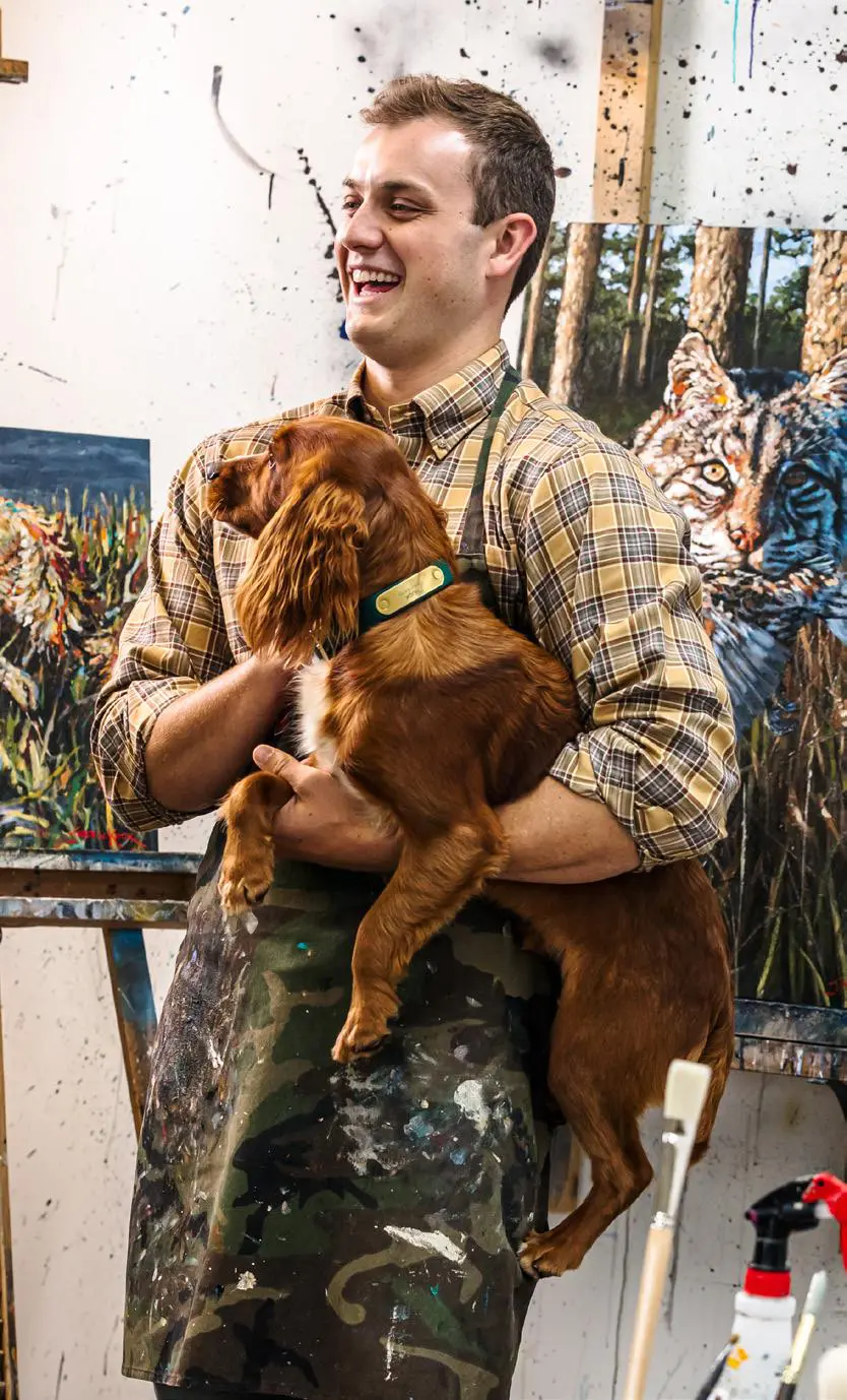 A man holding a dog in his arms.